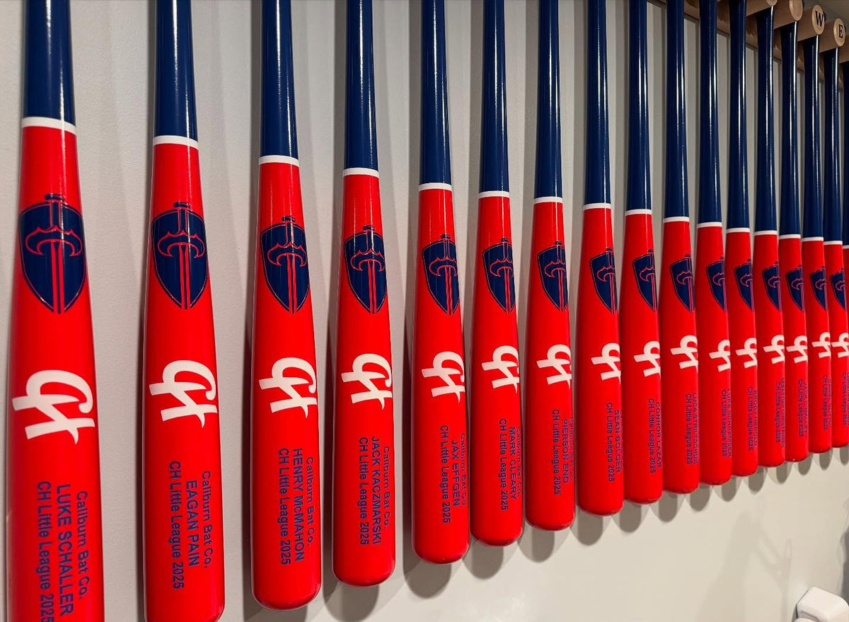 Custom Clarendon Little League team bats with matching logos and engraved player names