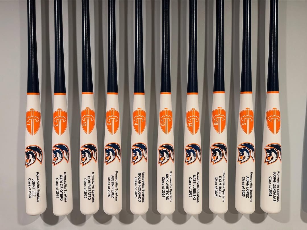 Row of custom Caliburn team bats engraved with player names