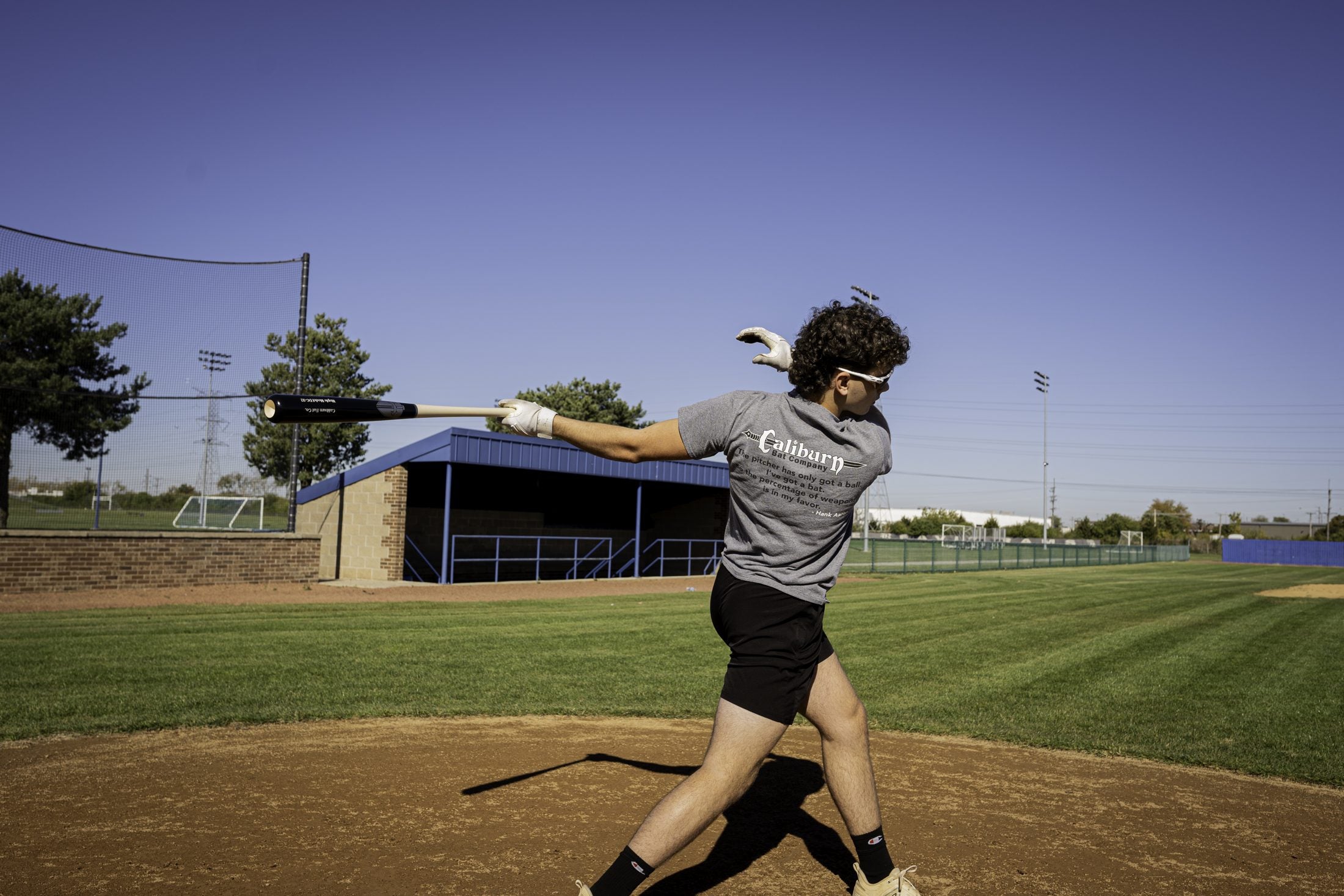 Player taking a swing with a Caliburn bat