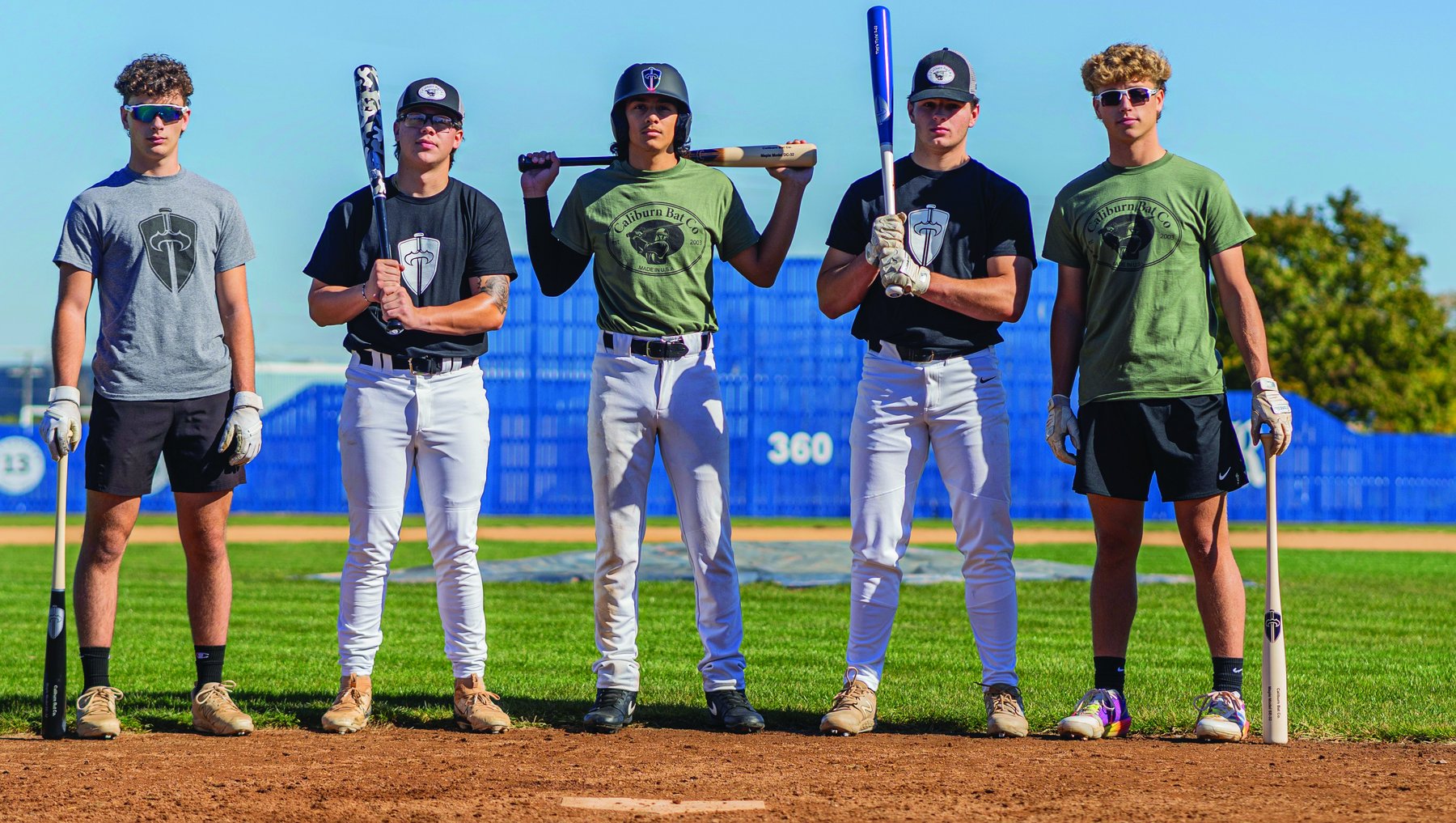 Caliburn team holding bats